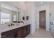 Well-lit bathroom with double sinks, sleek fixtures, and access to a modern glass shower for a luxurious experience at 23978 S 218Th Pl, Queen Creek, AZ 85142