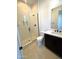 Contemporary bathroom features a glass walk-in shower, dark fixtures, and a floating shelf at 23978 S 218Th Pl, Queen Creek, AZ 85142