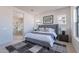 Comfortable bedroom with a stylish bed, soft lighting, and easy access to an ensuite bathroom, creating a relaxing retreat at 23978 S 218Th Pl, Queen Creek, AZ 85142