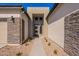 Home's entrance has a welcoming walkway that is beautifully designed with stone accents, leading to a modern front door at 23978 S 218Th Pl, Queen Creek, AZ 85142