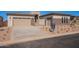 Charming home with a modern exterior, stone accents, well-kept yard, and a spacious two-car garage at 23978 S 218Th Pl, Queen Creek, AZ 85142