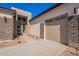 Home's exterior features stone accents, and a modern garage door, beautifully designed to invite you in at 23978 S 218Th Pl, Queen Creek, AZ 85142