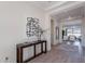 Inviting foyer with a view into the open-concept living space, showcasing modern decor and hardwood flooring at 23978 S 218Th Pl, Queen Creek, AZ 85142