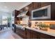 Modern kitchen design featuring stainless steel appliances and rich wood cabinetry at 23978 S 218Th Pl, Queen Creek, AZ 85142
