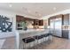 Spacious kitchen featuring a large central island with seating and stainless steel appliances at 23978 S 218Th Pl, Queen Creek, AZ 85142