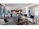 Inviting living room with stylish sofas, modern decor, and an open layout to the kitchen for seamless entertaining at 23978 S 218Th Pl, Queen Creek, AZ 85142