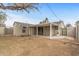 View of the back of the house, a covered patio, block wall, and low-maintenance yard at 1325 E Monte Vista E Rd, Phoenix, AZ 85006