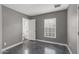Cozy bedroom featuring gray walls, a window with blinds, and an adjacent bathroom at 1325 E Monte Vista E Rd, Phoenix, AZ 85006