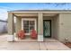 Inviting front porch with two red Adirondack chairs and a decorative green front door at 1325 E Monte Vista E Rd, Phoenix, AZ 85006