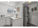 Charming kitchen featuring white countertops, stainless steel dishwasher and a stacked washer and dryer at 1325 E Monte Vista E Rd, Phoenix, AZ 85006