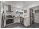 Well-equipped kitchen featuring stainless steel appliances, granite countertops, and a convenient laundry area at 1325 E Monte Vista E Rd, Phoenix, AZ 85006