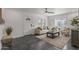 Cozy living room featuring sleek flooring, a ceiling fan, and ample seating at 1325 E Monte Vista E Rd, Phoenix, AZ 85006