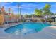 Backyard featuring a pool, waterfall feature, barbeque, outdoor seating, and mature trees at 1820 N 7Th Ave, Phoenix, AZ 85007