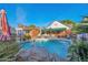 Backyard showcasing the beautiful blue pool with a waterfall feature and lounge chairs on the patio at 1820 N 7Th Ave, Phoenix, AZ 85007