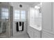 Bathroom featuring black and white tiled floor, glass enclosed shower, and built in vanity at 1820 N 7Th Ave, Phoenix, AZ 85007