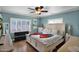 Bright bedroom boasts a king bed, shuttered windows, and neutral tones offering a serene and inviting space at 1820 N 7Th Ave, Phoenix, AZ 85007