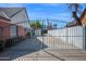 A long, gated driveway provides ample parking space and backyard access to the charming brick home at 1820 N 7Th Ave, Phoenix, AZ 85007