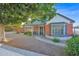Charming brick home featuring a cozy, gated porch and mature landscaping adding to its curb appeal at 1820 N 7Th Ave, Phoenix, AZ 85007