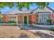 Charming brick home featuring a cozy, gated porch and mature landscaping adding to its curb appeal at 1820 N 7Th Ave, Phoenix, AZ 85007