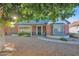 Charming brick home featuring a cozy, gated porch and mature landscaping adding to its curb appeal at 1820 N 7Th Ave, Phoenix, AZ 85007
