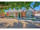 Charming brick home featuring a cozy, gated porch and mature landscaping adding to its curb appeal at 1820 N 7Th Ave, Phoenix, AZ 85007