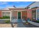 Charming brick home featuring a cozy, gated porch and mature landscaping adding to its curb appeal at 1820 N 7Th Ave, Phoenix, AZ 85007