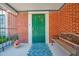 Charming front porch with a decorative door, brick facade, and cozy bench seating, creating a welcoming entrance at 1820 N 7Th Ave, Phoenix, AZ 85007