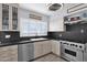 Kitchen with stainless steel appliances, a farmhouse sink, and tile backsplash at 1820 N 7Th Ave, Phoenix, AZ 85007