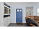 Comfortable living room with a blue front door, built-in cabinet and shelving, and an eye-catching pelican painting at 1820 N 7Th Ave, Phoenix, AZ 85007