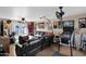 Spacious living room featuring an entertainment center, a ceiling fan, and comfortable seating at 1820 N 7Th Ave, Phoenix, AZ 85007