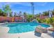 Beautiful pool with a rock waterfall feature, surrounded by lush landscaping, perfect for relaxation at 1820 N 7Th Ave, Phoenix, AZ 85007