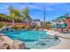 Backyard pool featuring a rock waterfall, poolside lounging area, and shimmering blue water on a sunny day at 1820 N 7Th Ave, Phoenix, AZ 85007