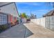 A long, gated driveway provides ample parking space and backyard access to the charming brick home at 1820 N 7Th Ave, Phoenix, AZ 85007