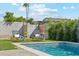 Well-maintained backyard featuring a sparkling pool and comfortable lounge chairs on manicured grass at 3125 N 86Th Pl, Scottsdale, AZ 85251