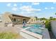 Backyard oasis featuring a pool, spa, and outdoor kitchen with a seating area at 3125 N 86Th Pl, Scottsdale, AZ 85251