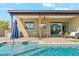 Lovely covered patio with dining table, outdoor kitchen and plush seating overlooking the pool at 3125 N 86Th Pl, Scottsdale, AZ 85251