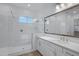 Bright bathroom featuring a glass-enclosed shower, modern fixtures, and a large mirror for a sleek look at 3624 N 59Th St, Mesa, AZ 85215