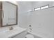 Bathroom with white vanity, framed mirror, and tub with shower at 3624 N 59Th St, Mesa, AZ 85215