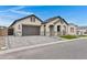 Inviting single-level home with a stylish garage door, paved driveway, and arched front porch at 3624 N 59Th St, Mesa, AZ 85215