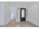 Open-concept entry with wood-look tile, black front door, and hallway view to a bright, modern space at 3624 N 59Th St, Mesa, AZ 85215