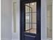 A sleek, dark-framed glass front door with an open view to a bright, modern interior space at 3624 N 59Th St, Mesa, AZ 85215