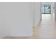 Bright hallway with light wood floors leading to a large sliding glass door with backyard views at 3624 N 59Th St, Mesa, AZ 85215