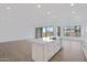 Spacious kitchen island with sink and dishwasher overlooking an open-plan living area and backyard view at 3624 N 59Th St, Mesa, AZ 85215