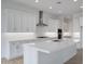 Stylish kitchen boasts white cabinets, stainless steel hood, and a spacious center island at 3624 N 59Th St, Mesa, AZ 85215