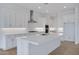 Beautiful kitchen featuring white cabinets, island with quartz countertop, and stainless appliances at 3624 N 59Th St, Mesa, AZ 85215