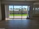 Bright living room with tile floors, large sliding glass doors showcasing a lush backyard with palms at 3624 N 59Th St, Mesa, AZ 85215