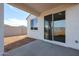 Back patio with sliding glass door looking out onto the yard at 40000 W Bravo Dr, Maricopa, AZ 85138