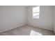 Sunlit bedroom with plush carpeting and a bright window offering an outside view at 40000 W Bravo Dr, Maricopa, AZ 85138