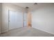 Bedroom features neutral walls, plush carpeting, and a closet providing ample storage space at 40000 W Bravo Dr, Maricopa, AZ 85138