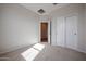 Bedroom features neutral walls, plush carpeting, and a closet providing ample storage space at 40000 W Bravo Dr, Maricopa, AZ 85138